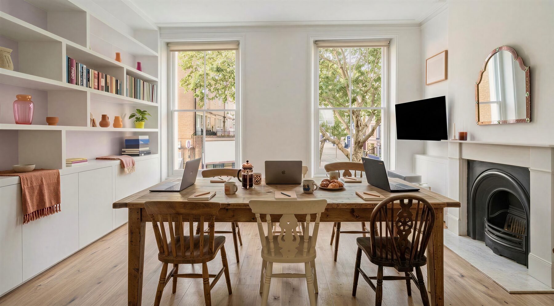 The Portobello Mornings workshop table: laptops, coffee and croissants by big sash windows over Portobello Road